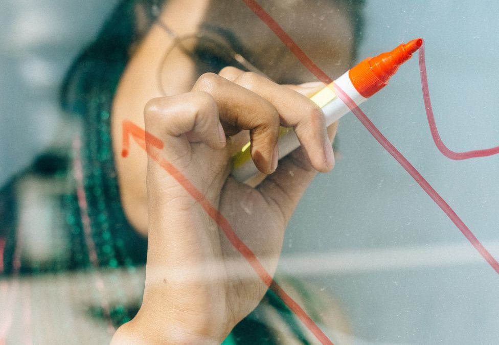 someone writing on glass