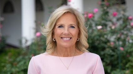 An image of Dr. Jill Biden. She is a woman with white skin, shoulder-length blonde hair, and she is wearing a pink shirt and smiling at the camera against an outdoor background. The header image leads to an article titled, "Milken Institute Launches New Women’s Health Network, Former First Lady Jill Biden Joins as its Chair".