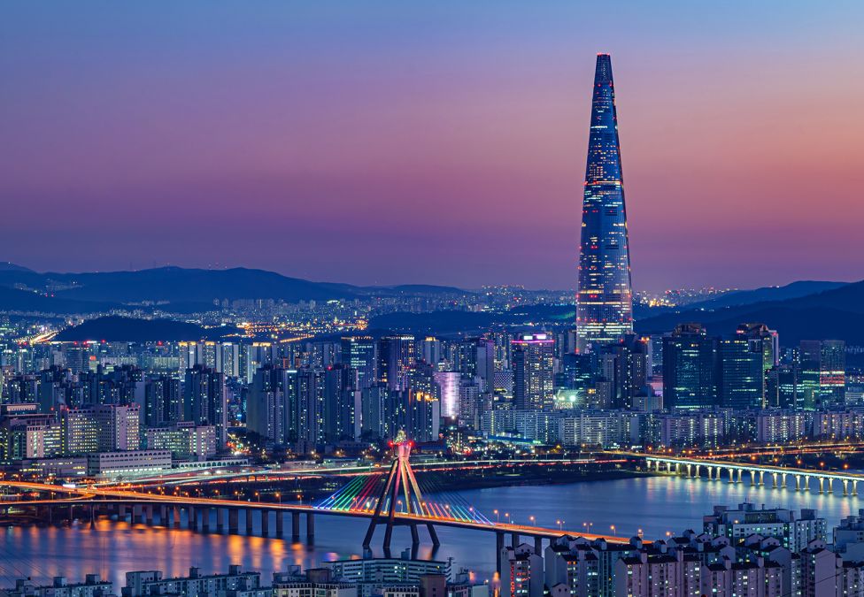 view of city in south korea with pink and purple skies