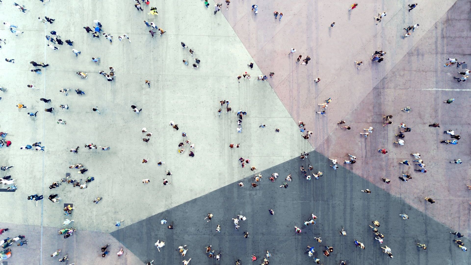 bird's eye view of people walking on top of a tri-colored large walkway