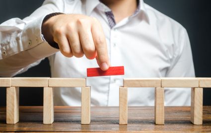Man assembling wooden blocks.