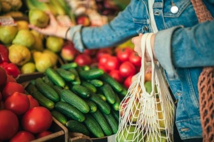 A person selecting fruits and vegetables.