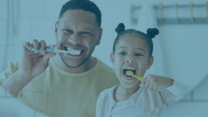 Father and daughter brushing teeth