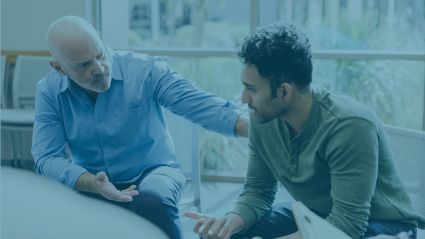 older man talking to younger man