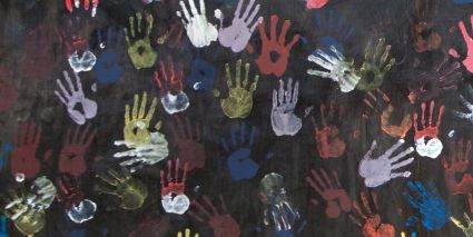 Painted handprints on a black background