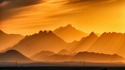 Mountaintops at sunset with an orange haze over them