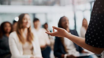 A speaker talking to a room of people