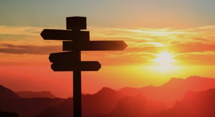 A roadsign against a sunset backdrop