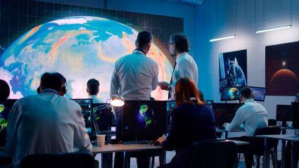 people looking at an image of the globe