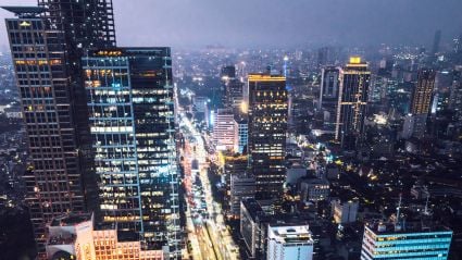 An aerial shot of a downtown of a city at night