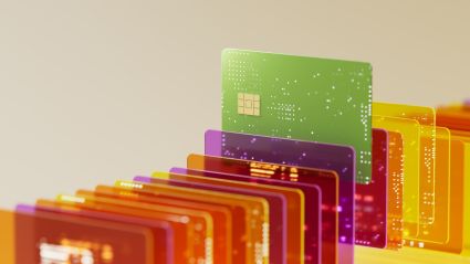 An image of a row of colorful transparent credit cards, with a lime green credit card slightly elevated above the rest.
