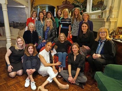 A group photo of a woman named Gloria Steinem and several women from the Milken Institute.