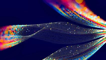An abstract graphic of various colorful orange and blue mixed swirling lines against a dark blue background. 