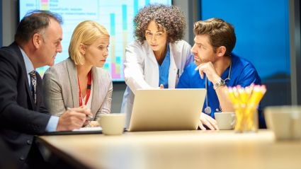 A group of people around a laptop