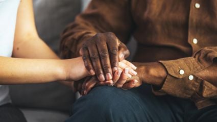 Two people holding hands