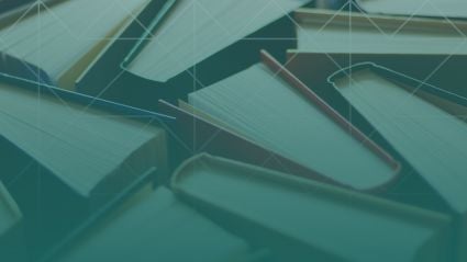 Overhead view of open and closed books layered together, creating a textured pattern that represents knowledge and learning.