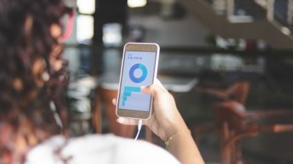 Abstract 3D render of glossy translucent panels arranged in a wave, transitioning from purple to orange.