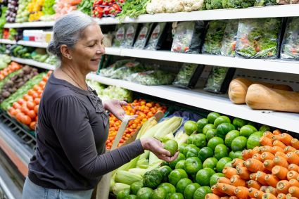 Woman shopping for fresh produce in grocery store