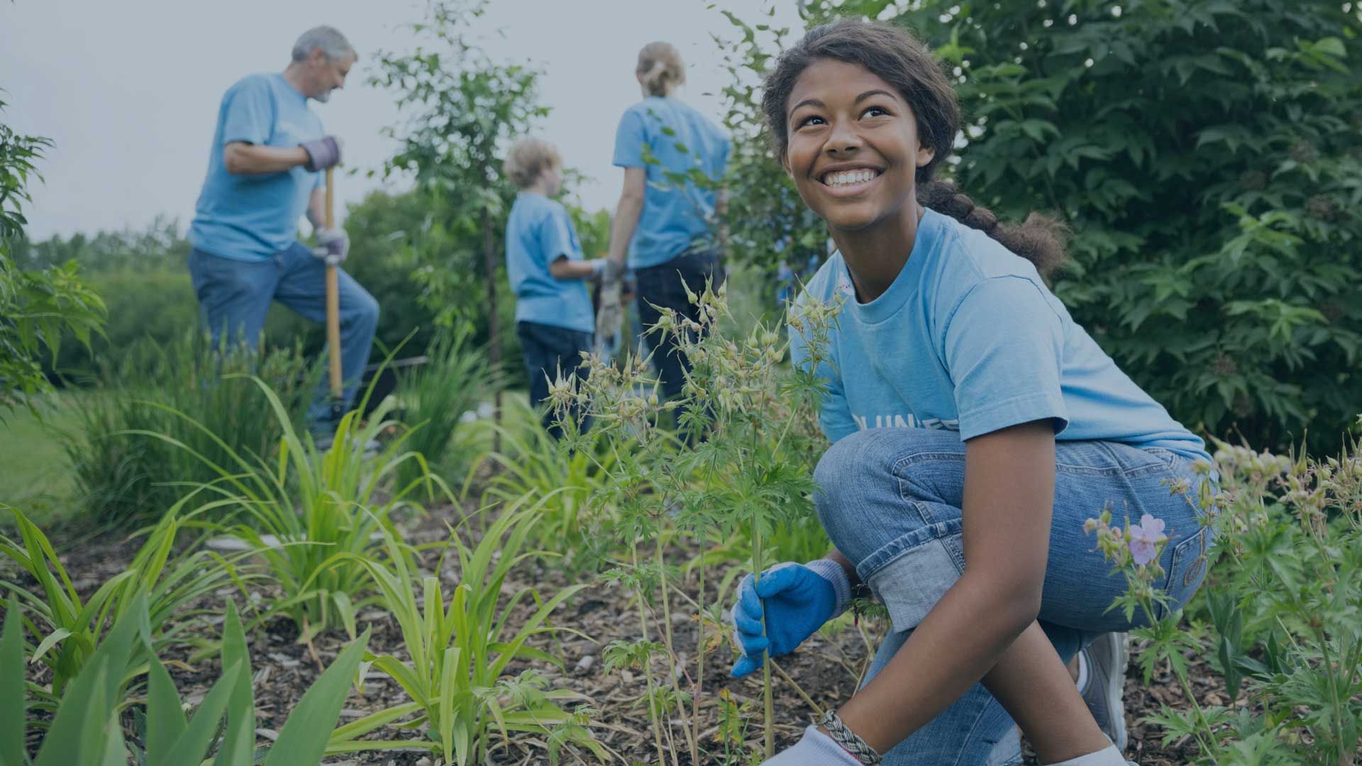 people working gardening in field together smiling
