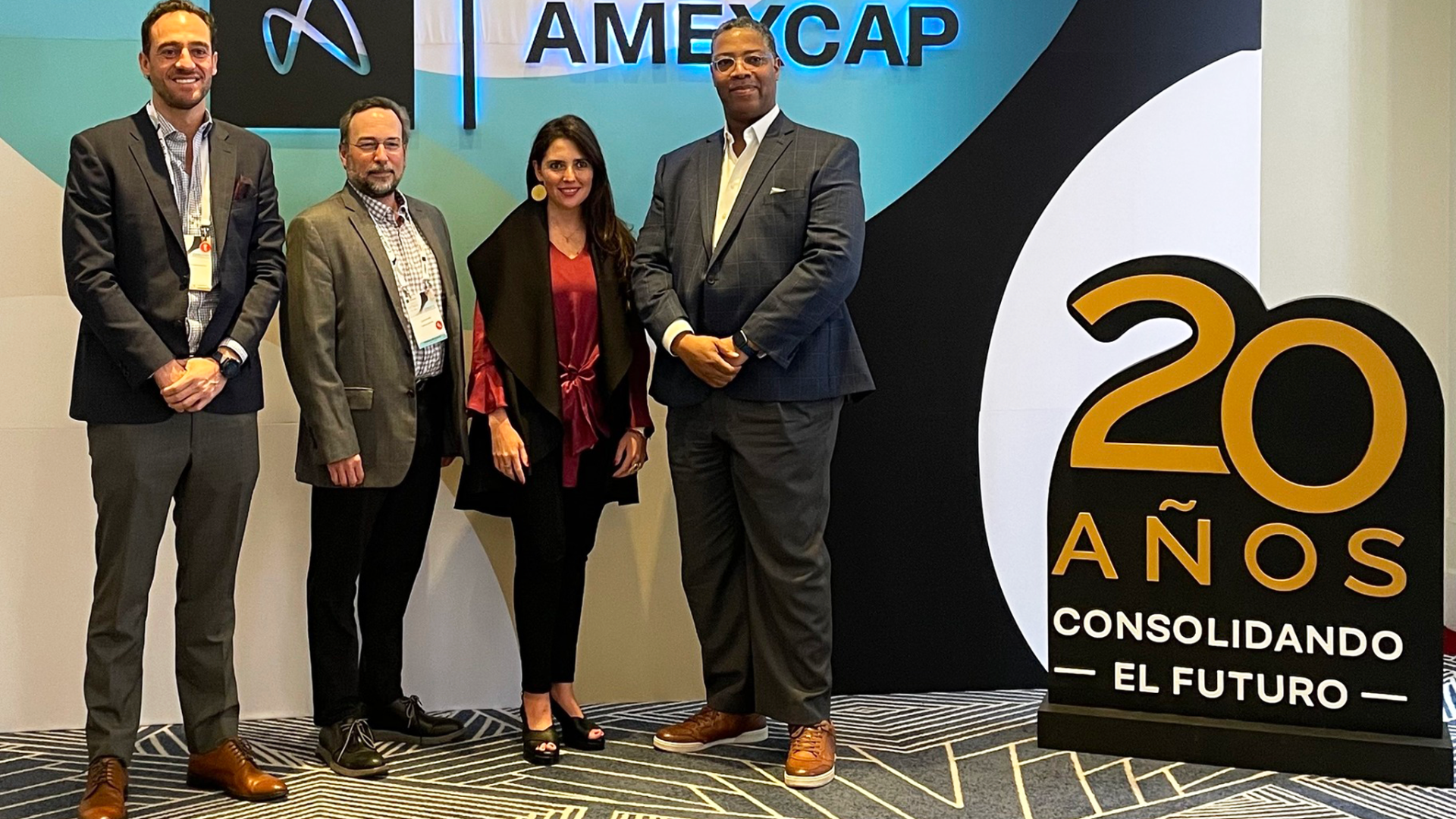 Three men and one female standing together at an event