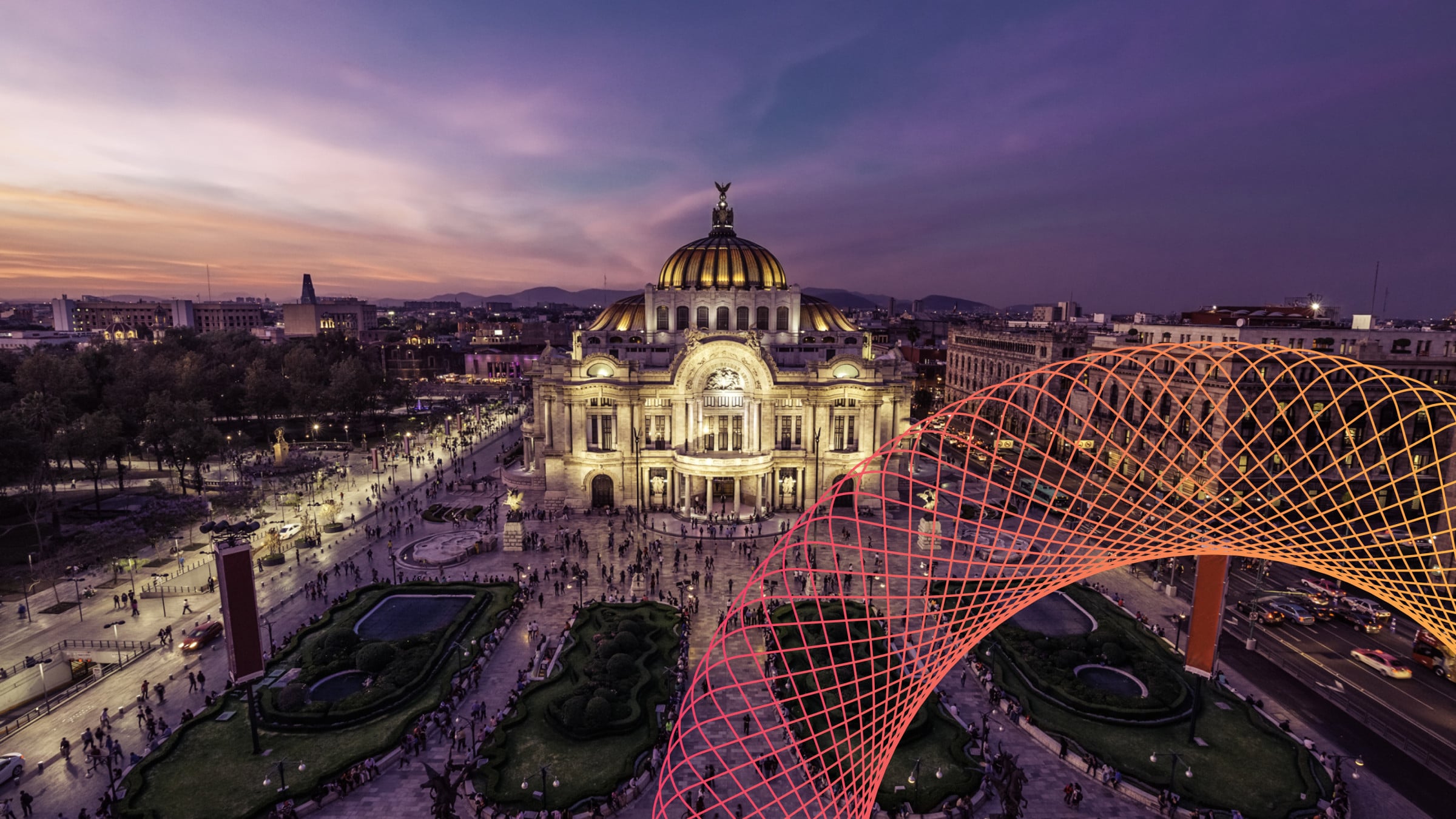 Aerial view of illuminated white cathedral and geodesic dome at dusk with purple sky