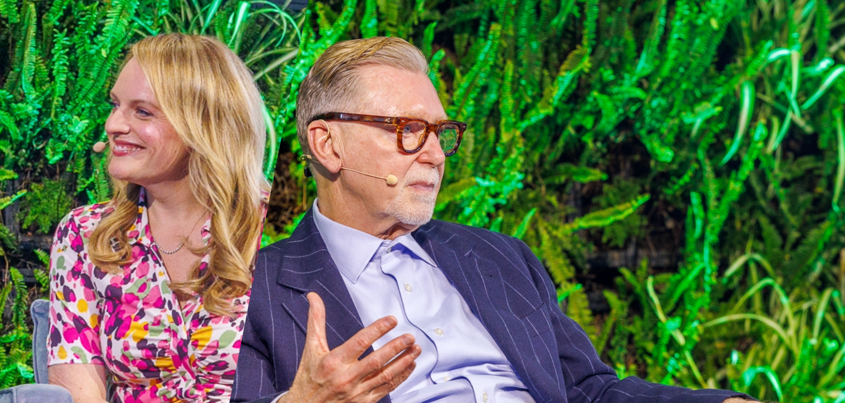 Woman in floral dress and man in glasses sit outdoors against green foliage backdrop