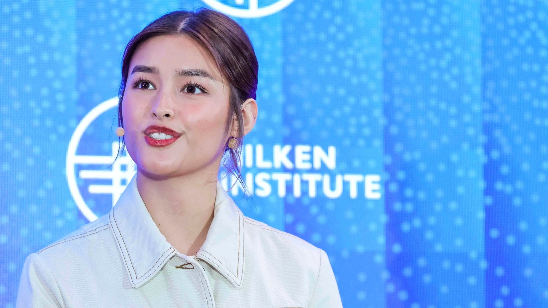 Liza Soberano in white collared shirt against blue background with Milken Institute logo