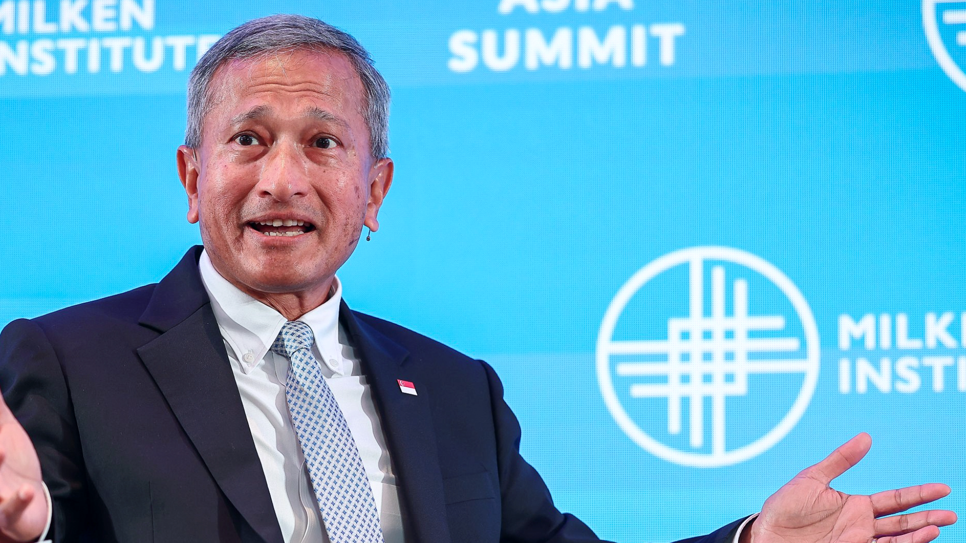 Vivian Balakrishnan speaking at Milken Institute Summit with blue backdrop