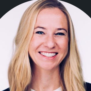 A smiling light-skinned female with blonde hair against a white and black background
