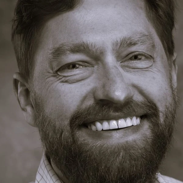 A smiling light-skinned male with a beard