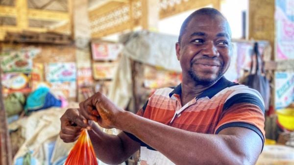 Man Holding Red Bag at Lamarana Sow Kolda Market