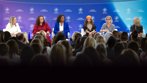 people on a panel at global conference in 2024