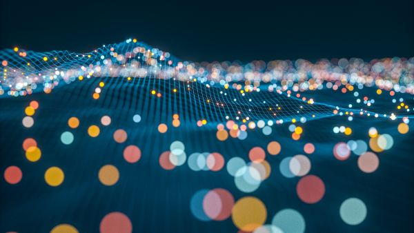 An image of abstract colorful dots over wavy blue lines, leading to a newsletter about the Milken Institute's Inclusive Capitalism Program.