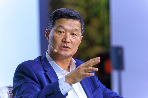 An image of Hon Pak, who spoke at the Milken Institute Global Conference in May 2025. He is Asian in appearance and has short black hair, brown eyes, and white skin. He is speaking and wearing a blue suit.