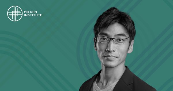Portrait of a man with short dark hair and glasses, wearing a blazer over a T-shirt, on a teal background with the Milken Institute logo in the top left corner.