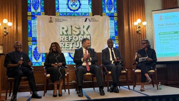 Five panelists sit on stage in front of a banner reading “Risk | Reform | Return: Nigeria Investment Forum,” engaged in discussion about investing in Nigeria’s trade infrastructure.