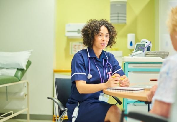 Health care provider consults with a patient during an appointment in a medical office.