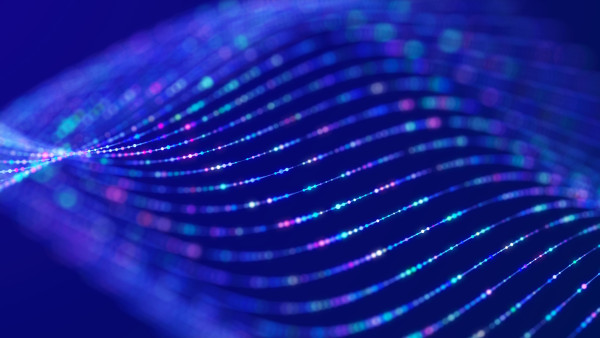 Close-up of blue circuit board with glowing traces and shallow depth of field