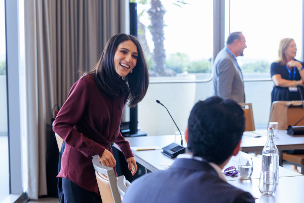 Business professionals collaborating in modern office meeting room with city view