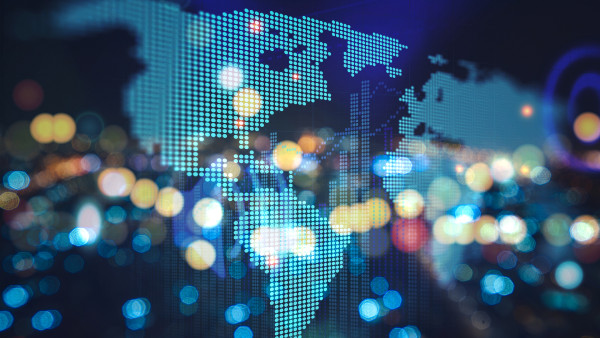 Illuminated pixelated world map with glowing blue dots and bokeh lights in background