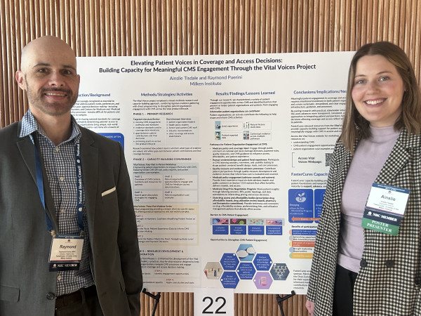 Two researchers standing beside their academic poster presentation numbered 22
