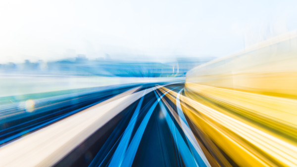 Motion-blurred view from inside a moving train or subway with vibrant blue and yellow streaks