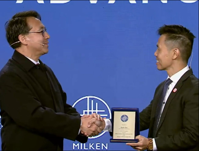 a man shaking hands and handing a plaque to another man