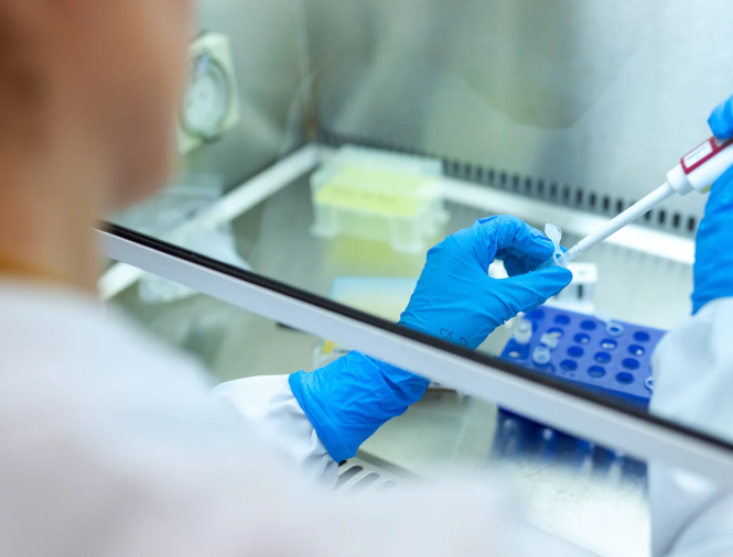 Scientist in lab using a syringe