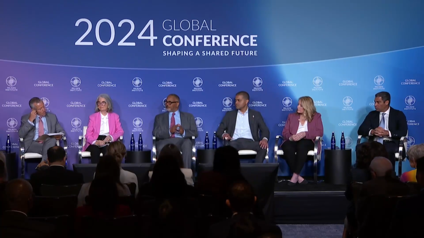 An image of multiple speakers onstage at the Milken Institute's 2024 Global Conference speaking about The Future of Gun Violence Prevention.