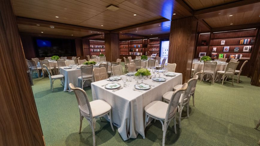 The Founders' Library set for a seated reception, with white-clothed tables under wood beams