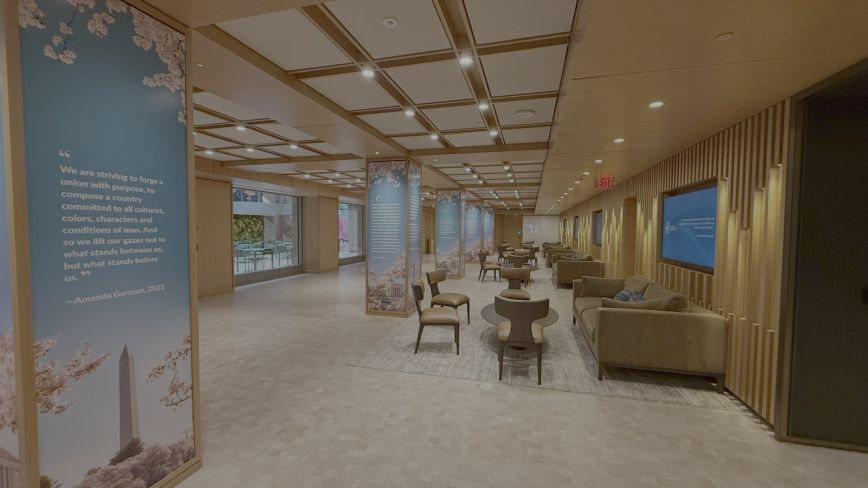 The Level Two Foyer arranged for networking, with lounge seating under wood-beamed ceilings