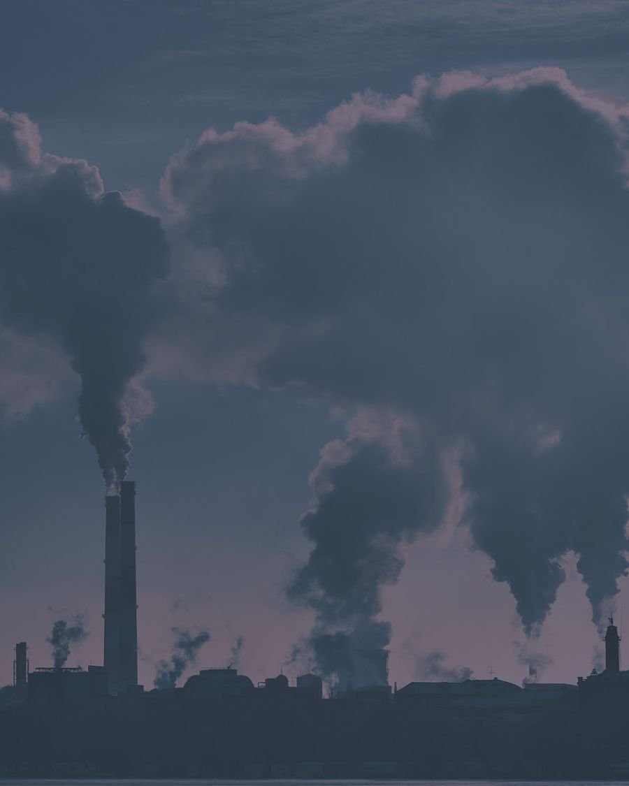 Several factories sending up smoke stacks into the sky