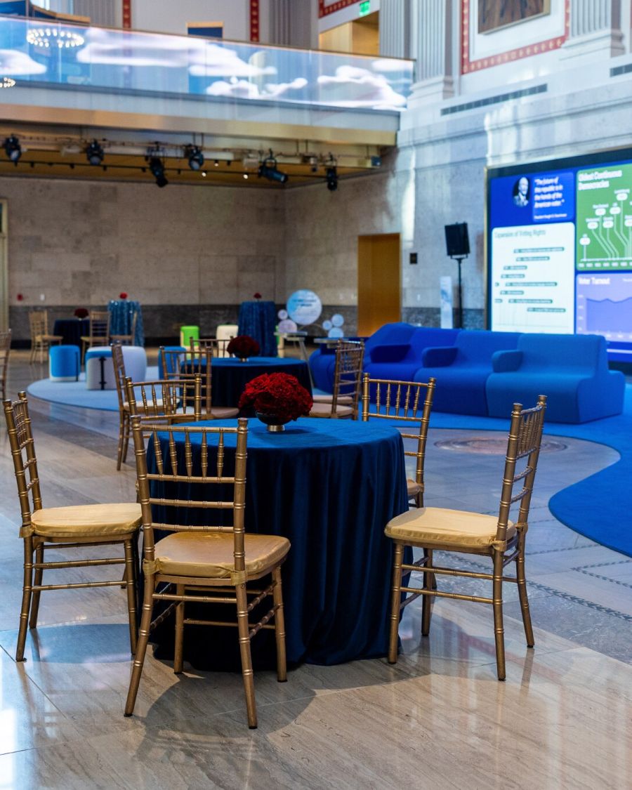 The Hall of Dreams set for a cocktail reception with blue-draped rounds and gold chiavari chairs