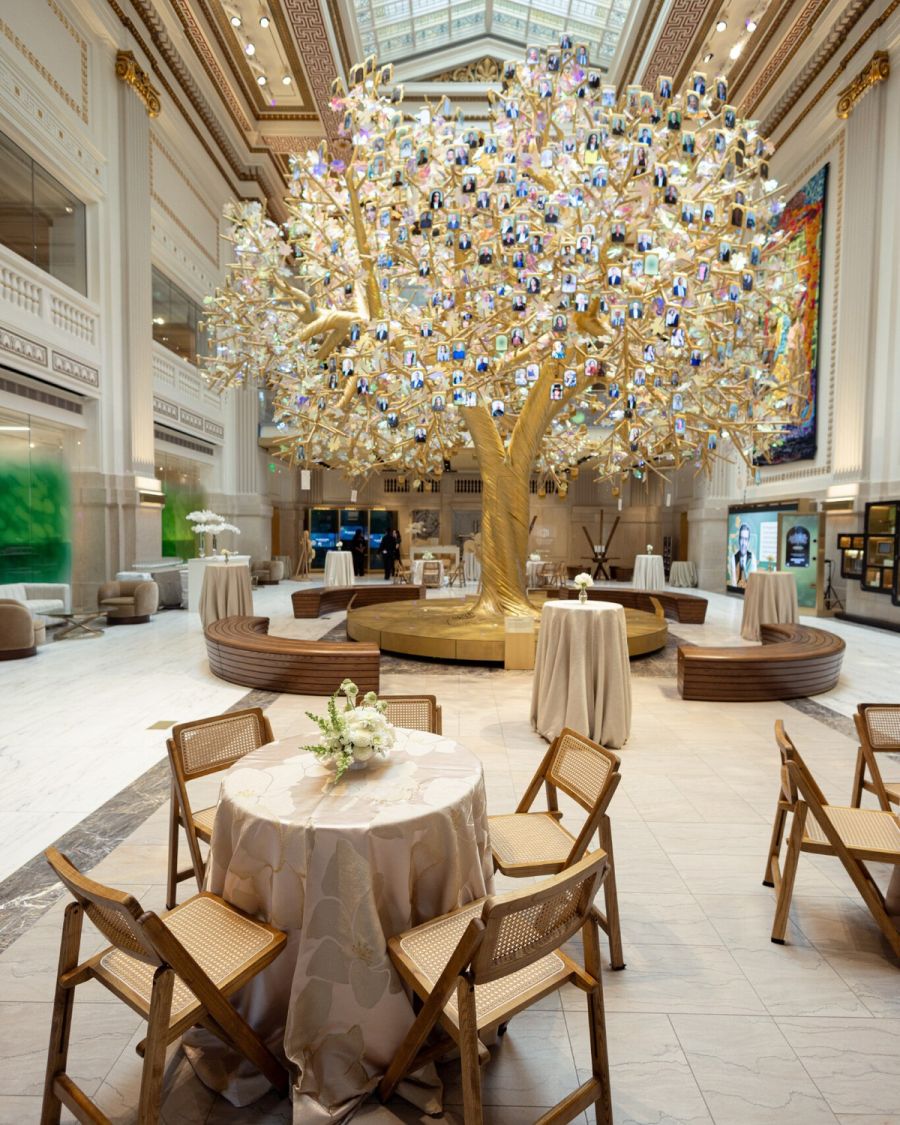 Daylit seating beneath the golden Dream Tree in the Hall of Generations
